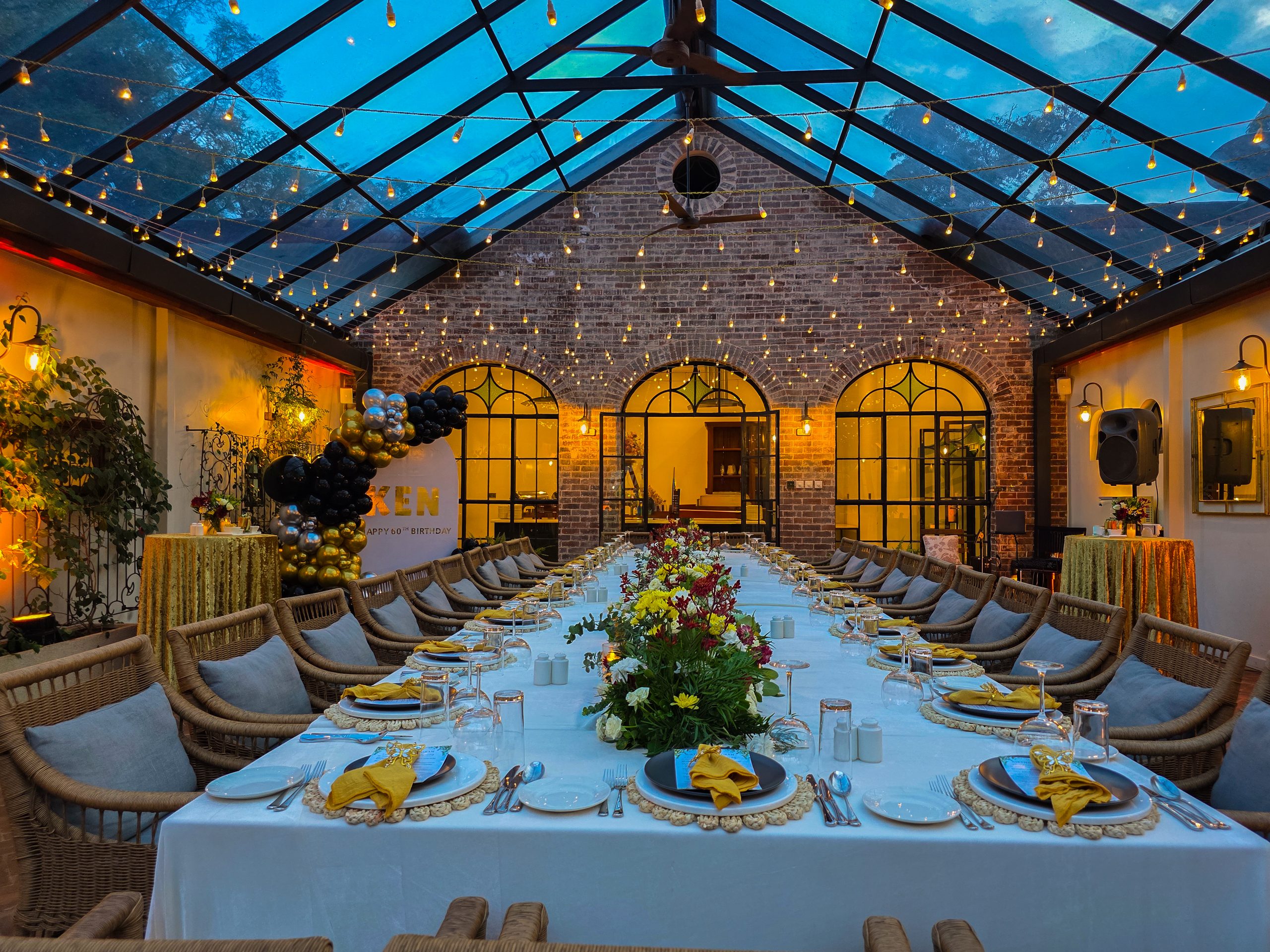 Candlelit corporate dinner inside the Atrium Glasshouse at Karen Blixen Coffee Garden in Karen, Nairobi